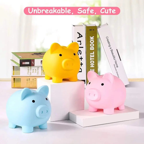 A collection of yellow and pink pig-shaped coin storage banks and books on a white surface.