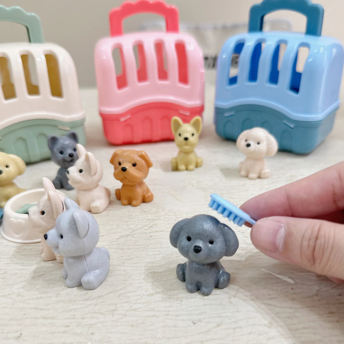 A collection of eight small dog toys in various colors and shapes, including a basket-shaped toy, displayed on a light surfac
