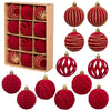 A set of twelve red velvet Christmas hanging ornaments, some with gold glitter accents, displayed in a cardboard box.