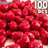 A close-up view of many red heart-shaped latex balloons used for party decoration.