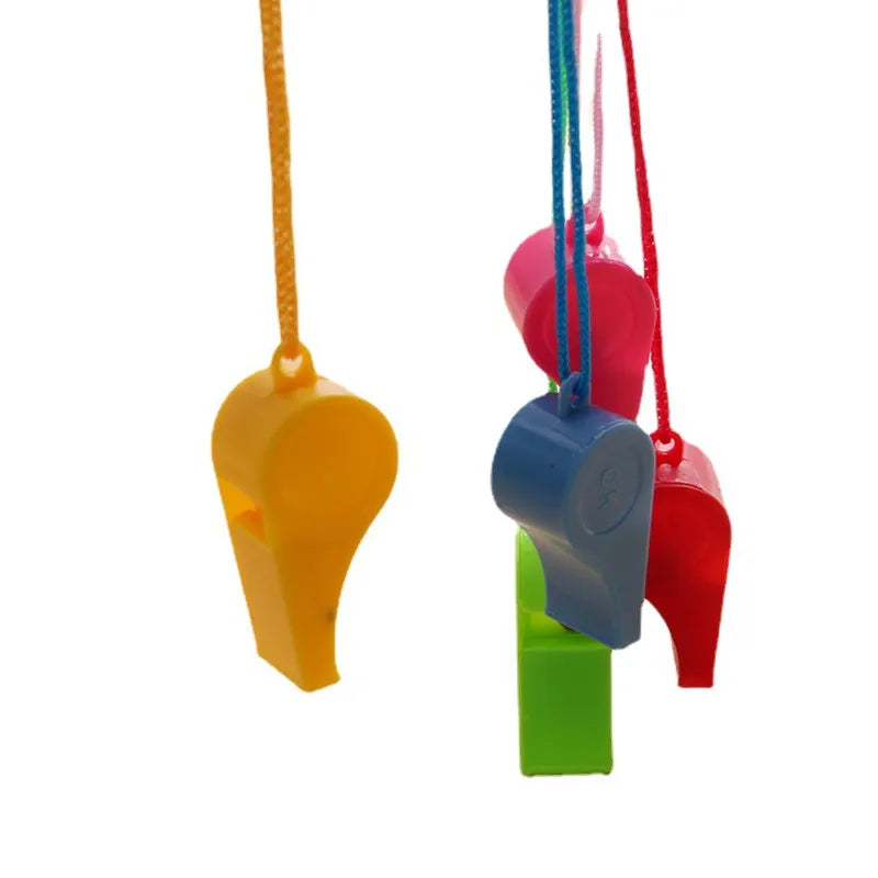 A collection of colorful plastic whistles hanging from lanyards in yellow, pink, blue, and red.