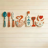 A set of seven rustic wooden kitchen decor pieces including a fork, knife, cup, wine glass, and heart shape displayed on a li