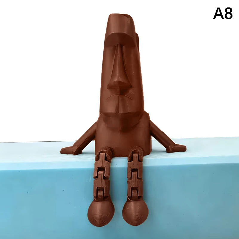 A 3D printed Moai statue figurine with movable joints, colored brown, standing on a light blue surface.