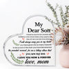 A heart-shaped acrylic keepsake plaque with engraved text saying I love you now and forever from a mother to her son.