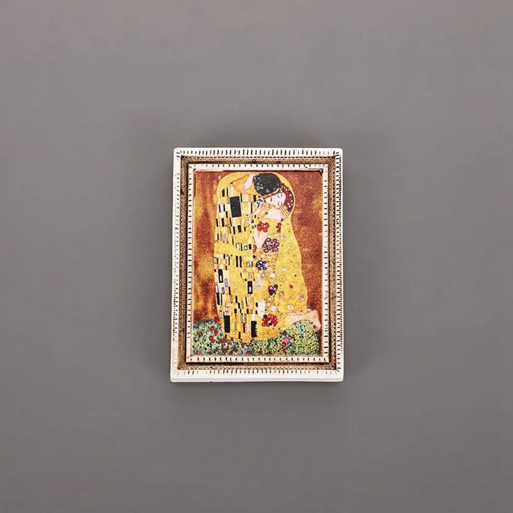 A framed painting featuring a woman in yellow and gold against an orange background, displayed as a fridge magnet.