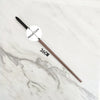 A long, slender metal wand replica with a circular head and a 36cm length resting on a white marble surface.