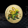 A gold-colored collectible coin featuring a fierce green mythical beast with yellow accents and a Tai Chi motif.