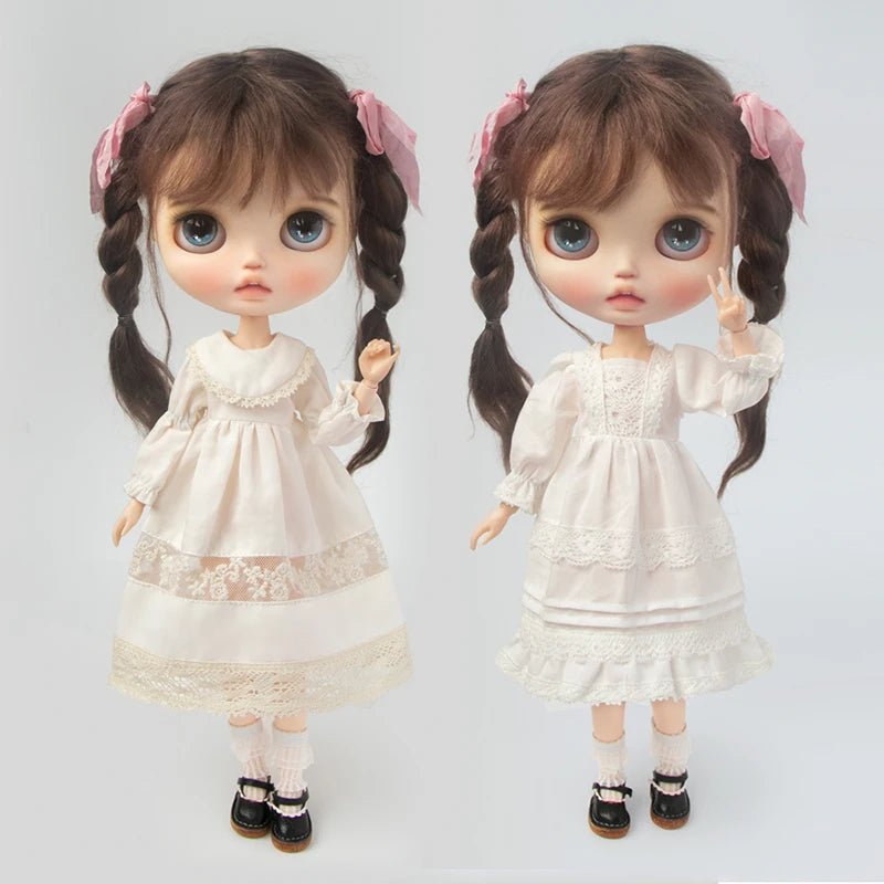 A pair of vintage lace pajama sets for 1/6 dolls, featuring white fabric and pink accents.