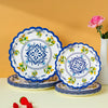 A stack of blue and white floral disposable paper plates with yellow accents on a light surface.