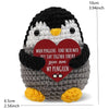 A handcrafted crochet penguin doll with a red heart tag that reads When penguins find their mate they stay together forever.
