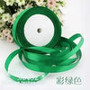 Rolls of green silk satin ribbon for crafting and decoration