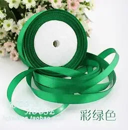 Rolls of green silk satin ribbon for crafting and decoration