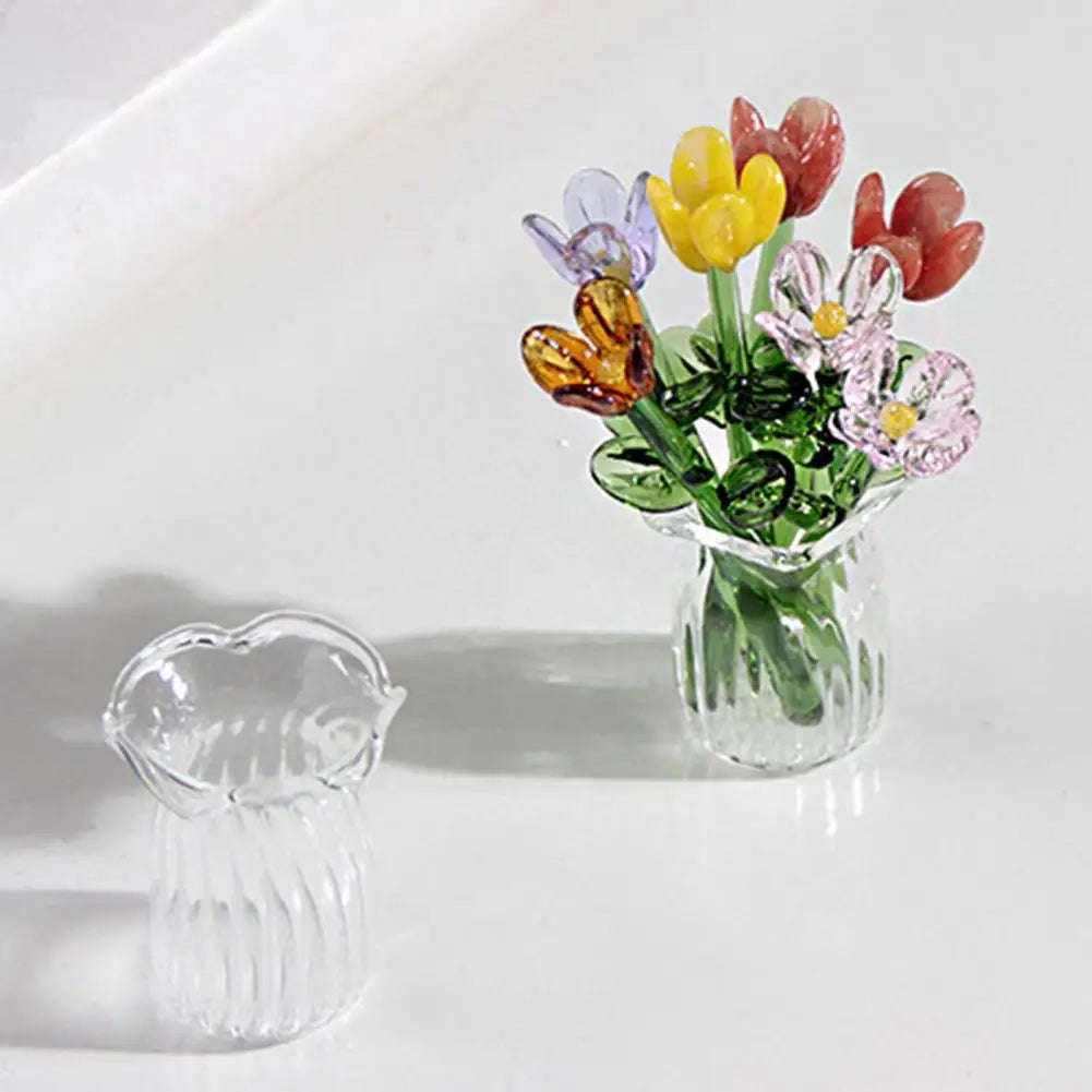 A hand-blown glass flower bouquet featuring yellow, purple, and reddish-pink blooms in a clear glass vase.