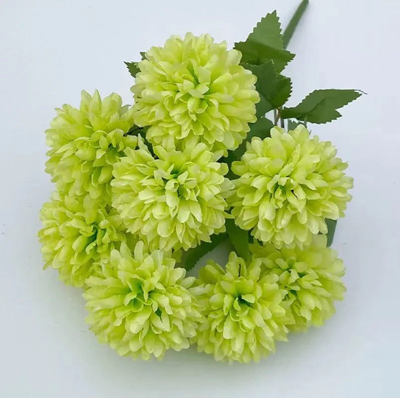 A bouquet of artificial light green hydrangea and camellia flowers.