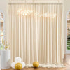 A cream-colored fabric backdrop with a 'Happy Birthday' sign and gold balloons, draped for an event.
