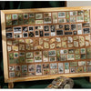 A wooden frame displays a collection of decorative washi tape squares for scrapbooking and crafting.