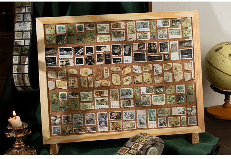 A wooden frame displays a collection of decorative washi tape squares for scrapbooking and crafting.