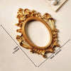 Vintage gold DIY shadow box frame with ornate carvings and a circular opening.