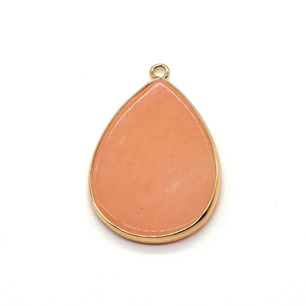 A teardrop-shaped rose quartz pendant charm with a gold-toned bezel setting.