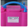 Pink electric balloon pump with a blue handle and pump mechanism.