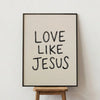 Framed wall art print with black text that reads Love Like Jesus on a light background.
