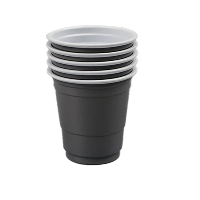 A stack of five disposable red shot glasses.