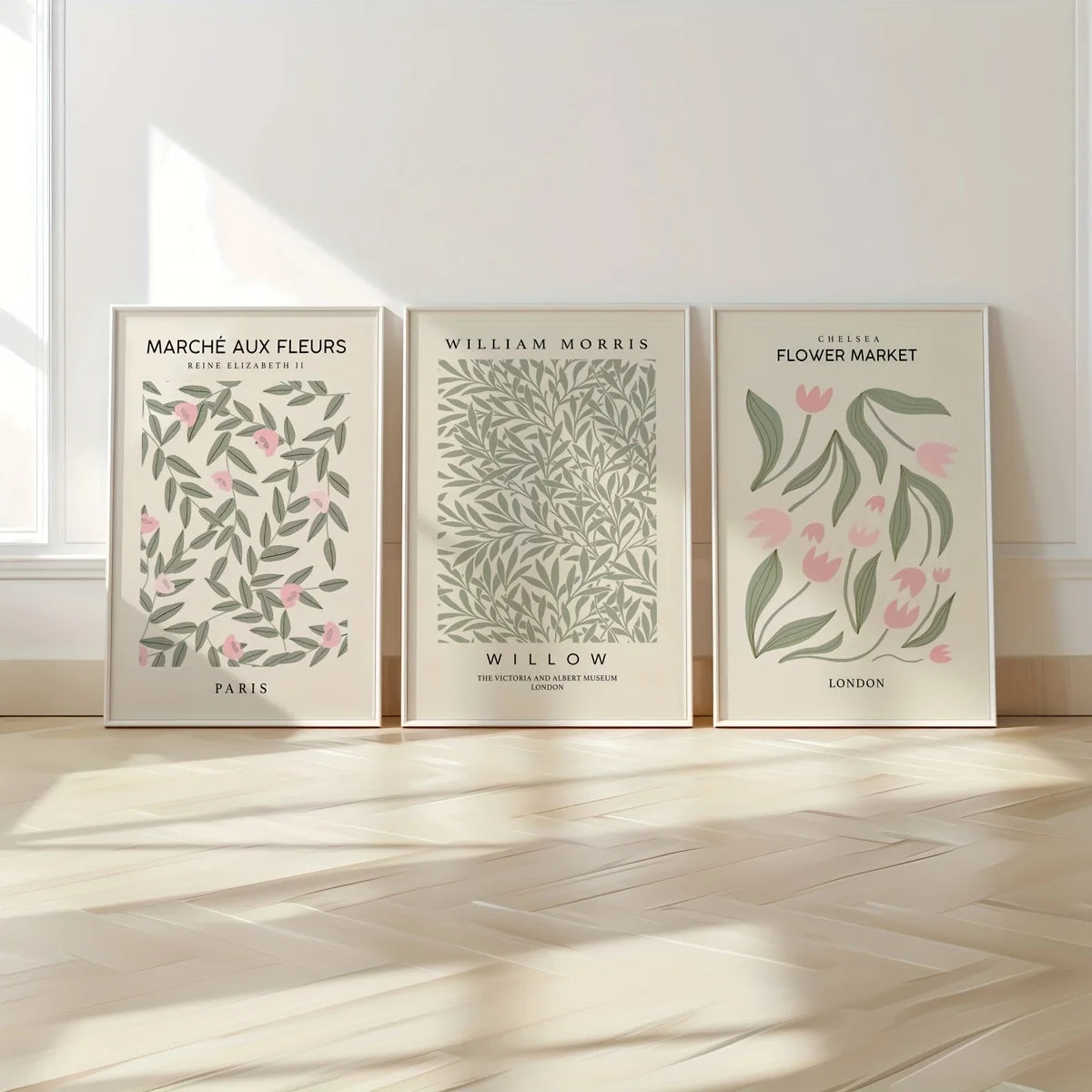 Three framed botanical prints featuring floral designs in muted green and pink tones on white backgrounds.