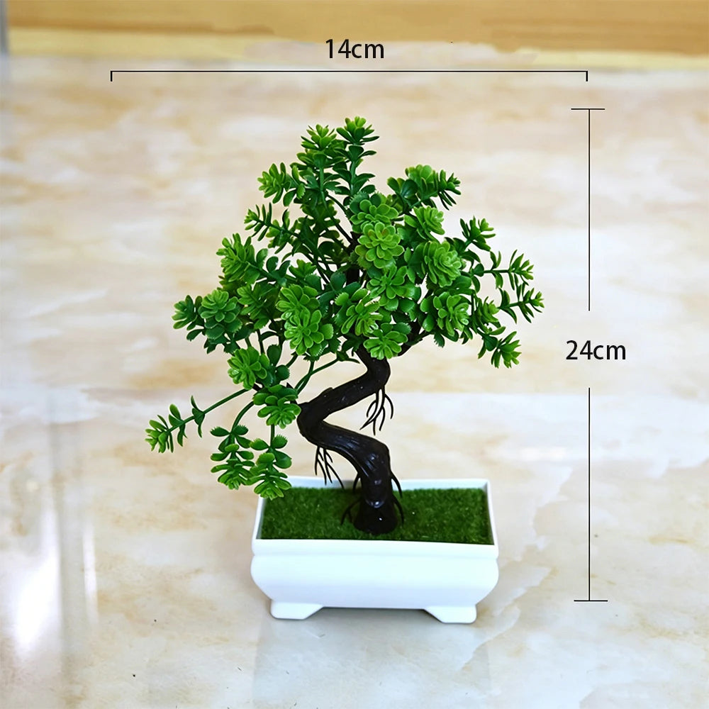 A small artificial bonsai tree with green foliage planted in a white rectangular pot.
