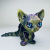 A detailed 3D printed figurine of a Siamese cat with purple and blue eyes.