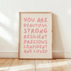 A framed canvas print with pink text that reads You are beautiful strong resilient precious confident and loved