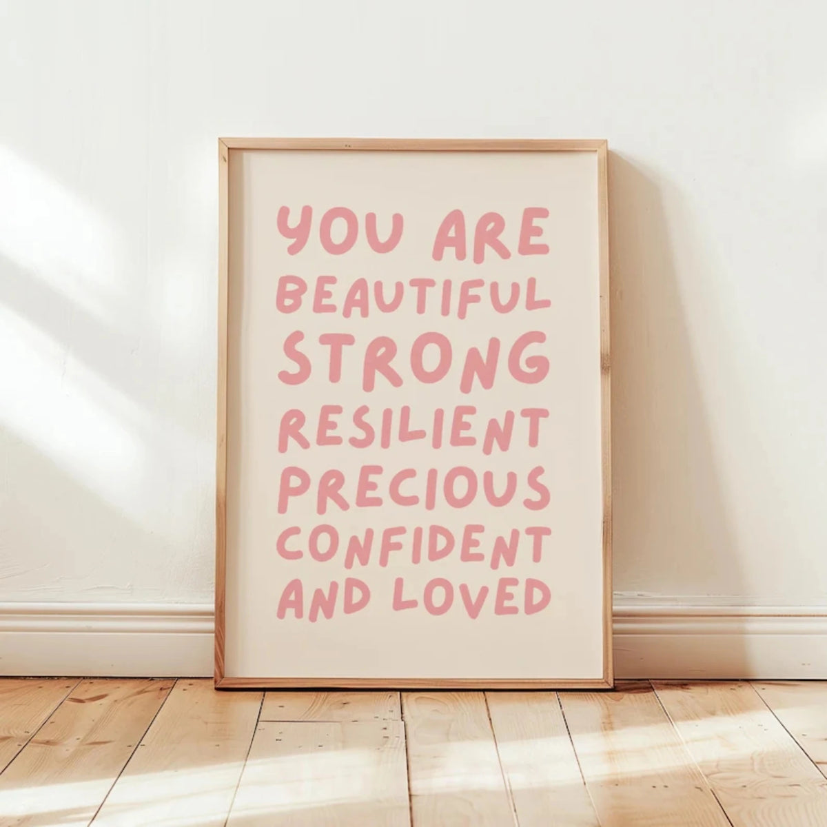 A framed canvas print with pink text that reads You are beautiful strong resilient precious confident and loved