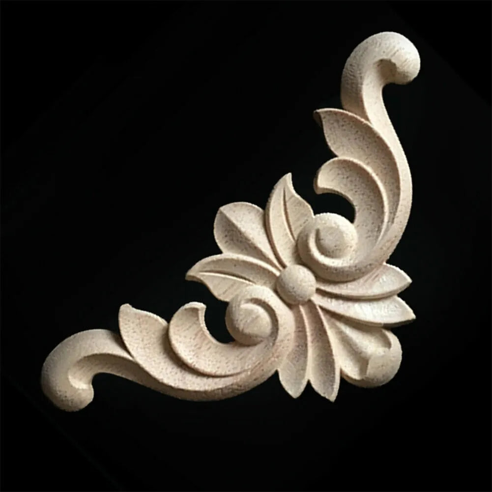 A light beige wooden carved corner applique featuring a swirling floral design.