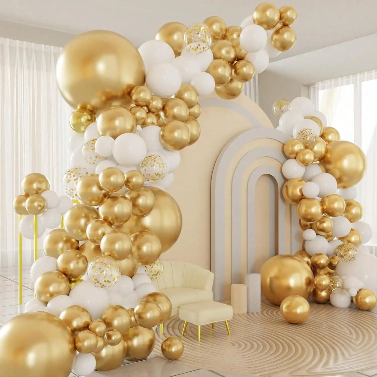 A large balloon garland featuring white and gold latex balloons with confetti arranged in an archway design.