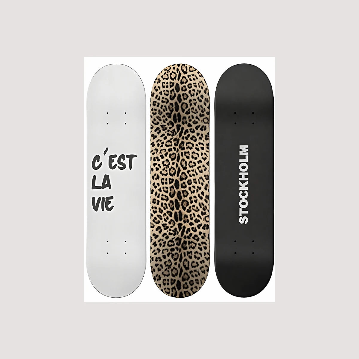 Three skateboard decks featuring white, leopard print, and black designs.
