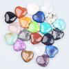 A collection of heart-shaped amethyst crystal stones in various colors including pink, orange, blue, and purple.