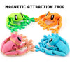 A set of three articulated 3D printed frog magnets in green, orange, and blue.