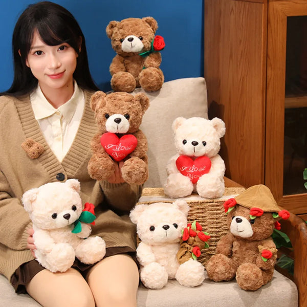 A woman is sitting surrounded by several teddy bear plush toys, including ones with hearts and roses.