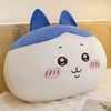 A soft blue and white Usagi Chiikawa plush doll sitting on a white fluffy surface.
