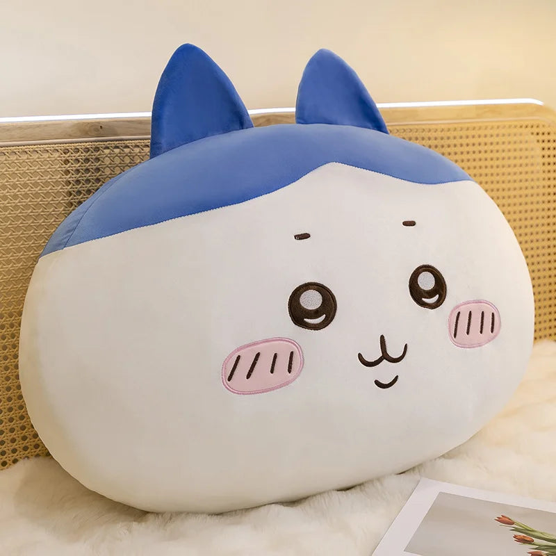 A soft blue and white Usagi Chiikawa plush doll sitting on a white fluffy surface.