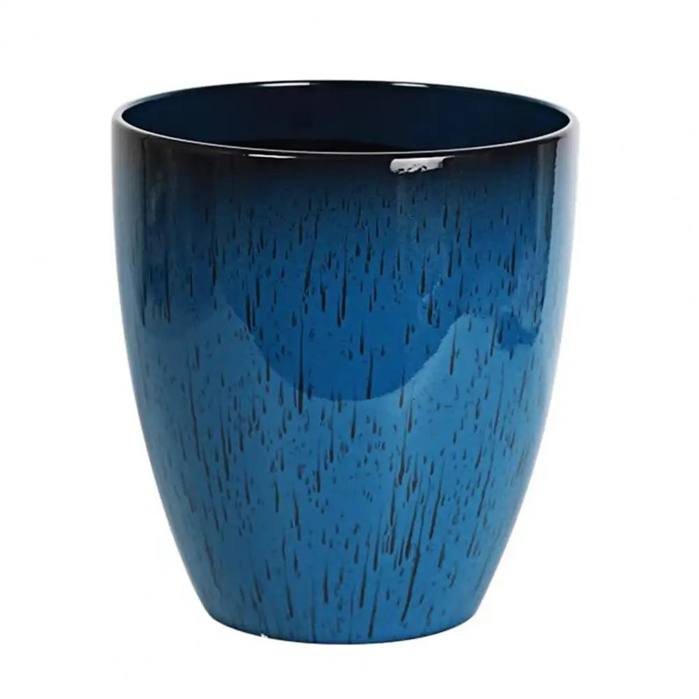 A deep blue, textured resin planter with a slightly flared rim and a small saucer.