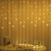 LED butterfly curtain lights hanging in a warm yellow drape with various light patterns