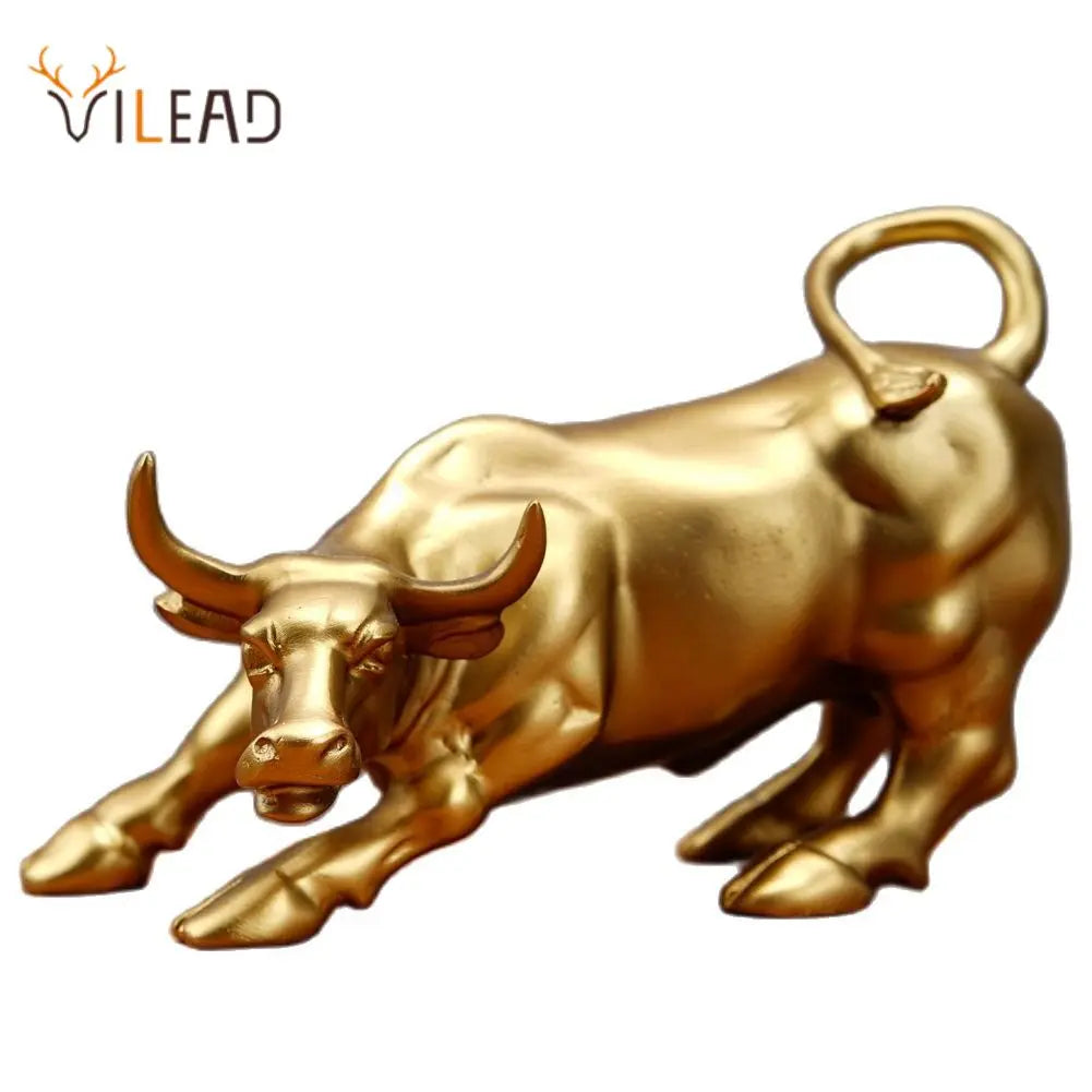 A golden sculpture of a bull with horns and a curved handle, used for home decor.