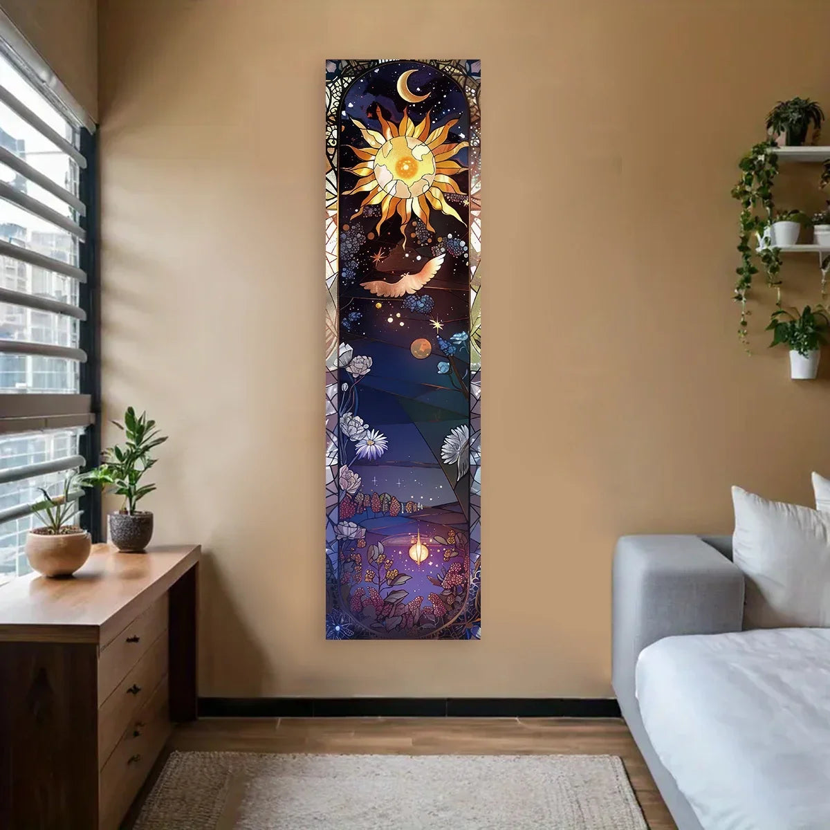 A vertical tapestry wall hanging depicting a sun and moon in a bohemian style on a beige wall.