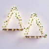 Two geometric triangles made of thin branches adorned with glowing artificial leaves for home decor