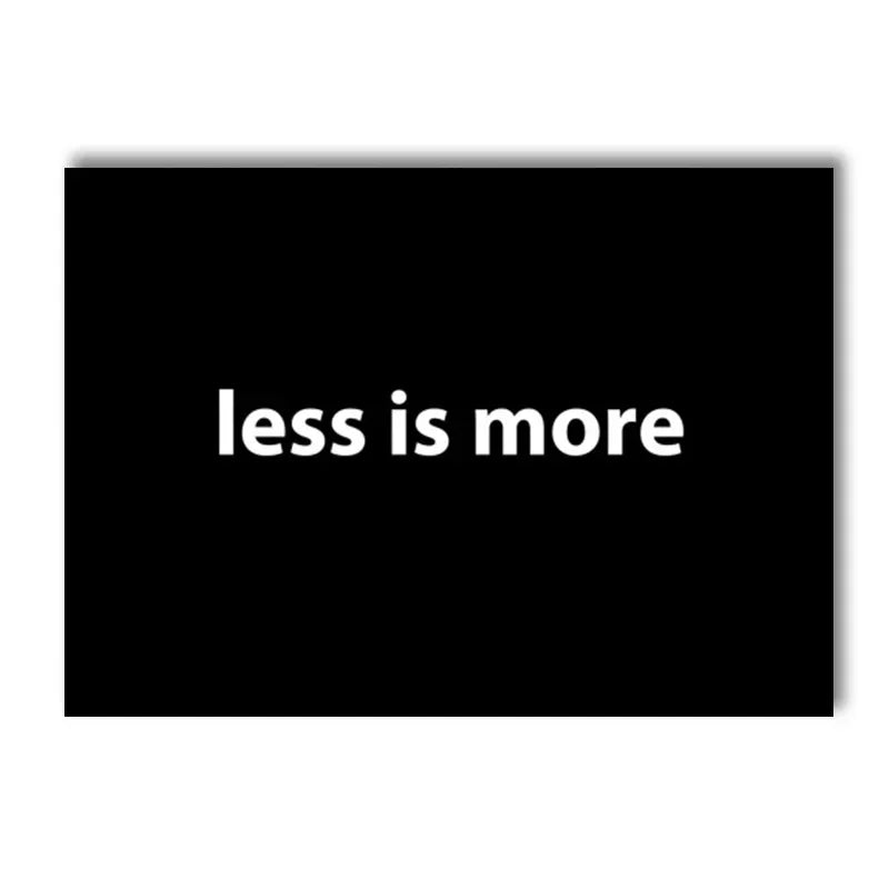 A black canvas art print featuring the motivational quote less is more in white text.