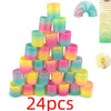 A stack of 24 colorful, translucent silicone spring toys in a rainbow gradient pattern.