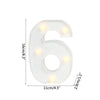 A white alphabet letter light shaped like the number six with warm white LED lights.