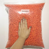 A hand is holding a clear bag filled with orange foam beads labeled Felicoalice.