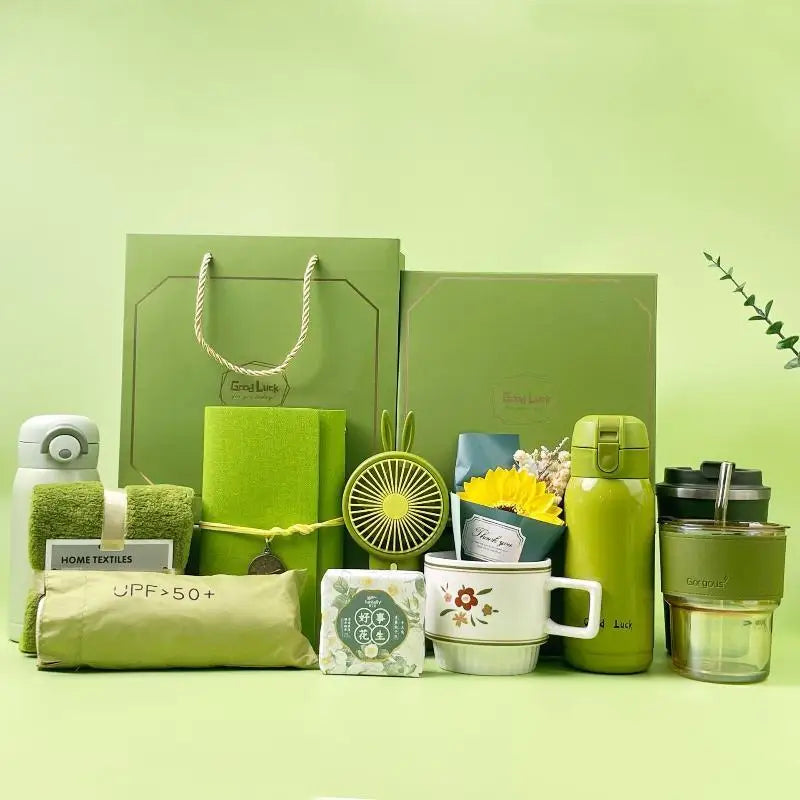 A green gift set featuring a tumbler, towel, and UPF sun protection items on a light green background.