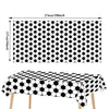 A black and white honeycomb pattern tablecloth displayed on a table.
